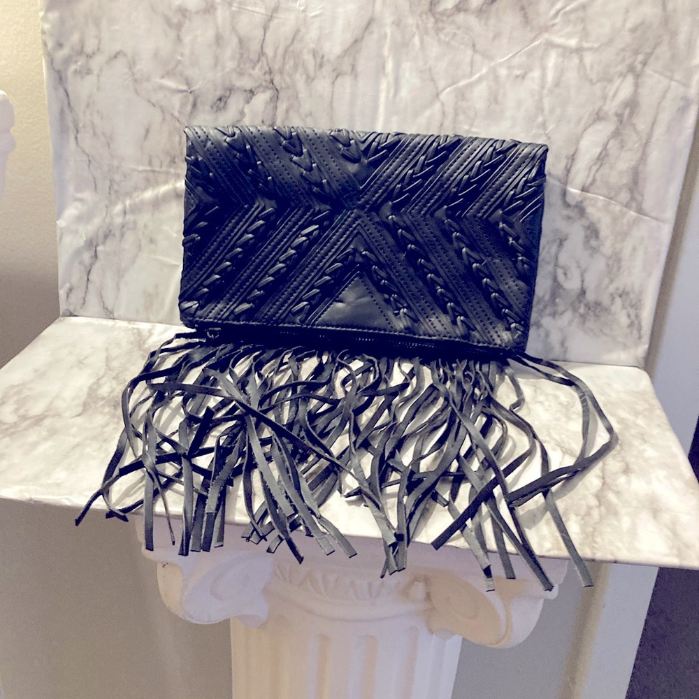 BCBG black fringe clutch.
